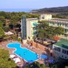 Hotel con piscina circondato da pinete.